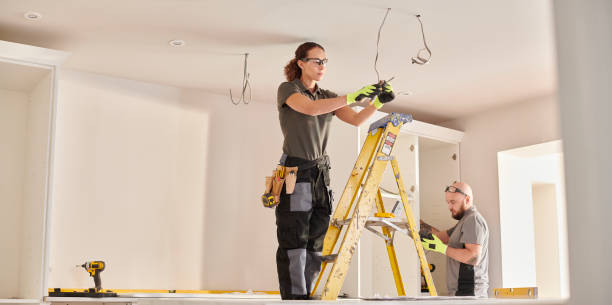 female electrician working in a kitchen remodelling